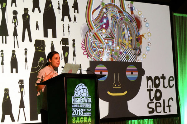 Manoush speaks to HighEdWeb with a brain-based graphic behind her