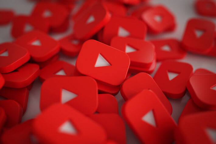 Photo illustration of YouTube play buttons as wooden blocks