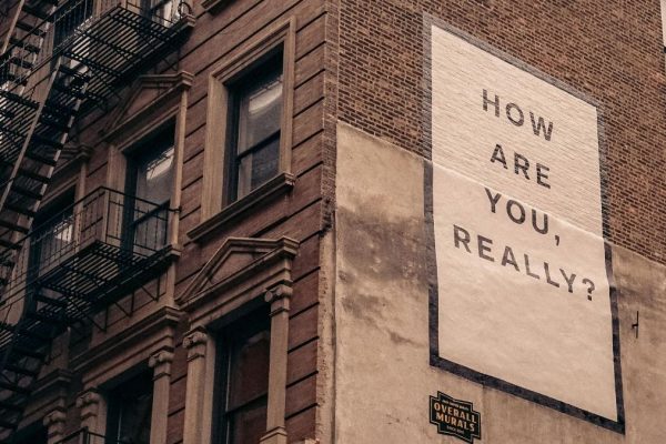 Sign on the side of a building that says: How are you really?
