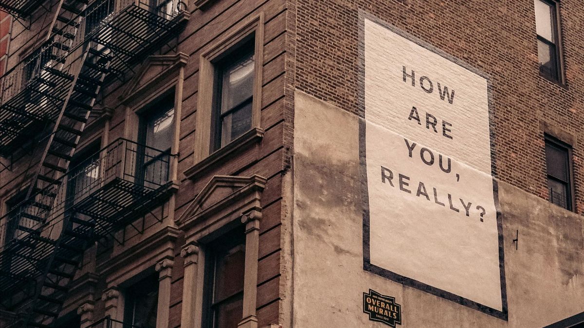 Sign on the side of a building that says: How are you really?